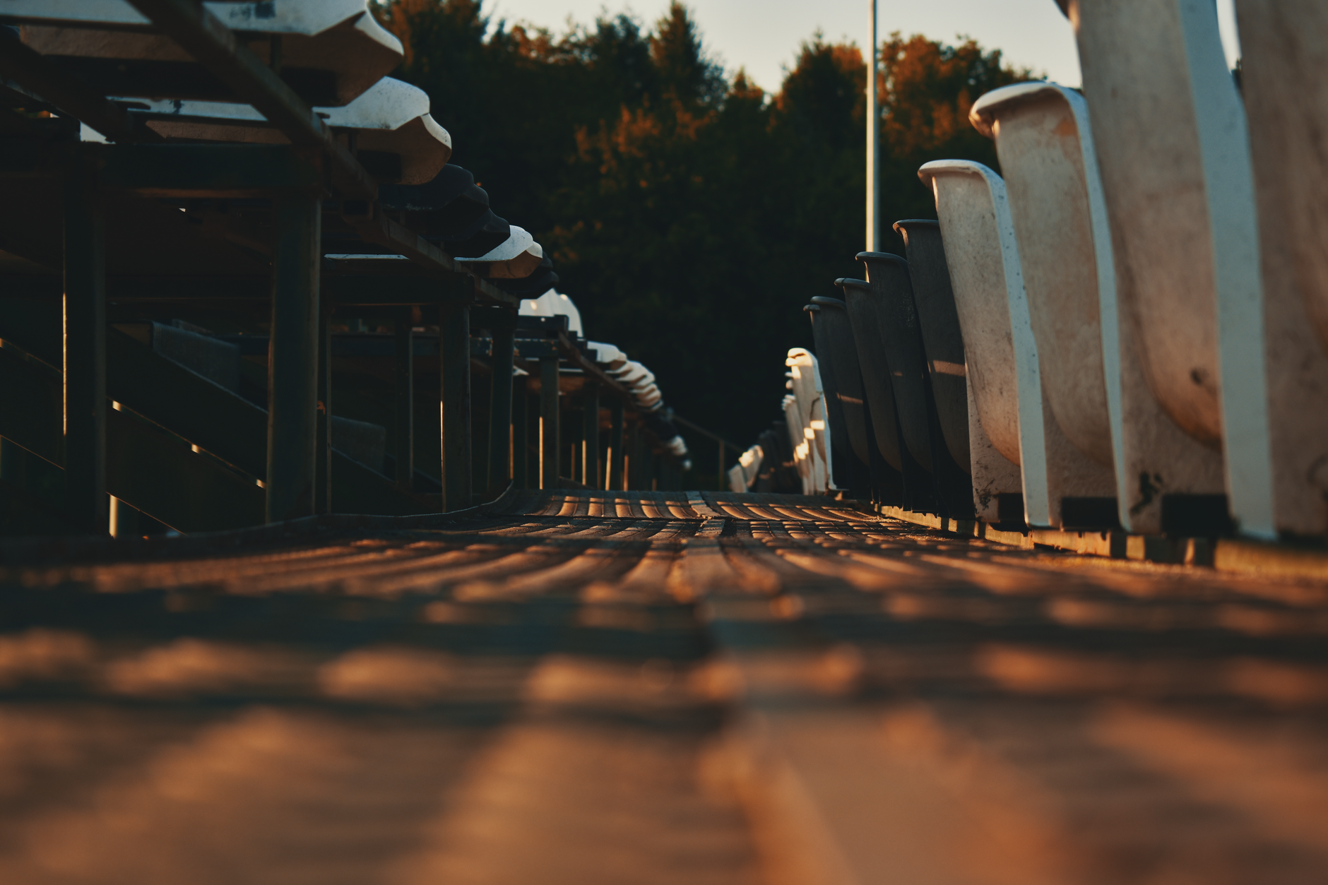 Rows of seats inside a soccer stadium under evening light